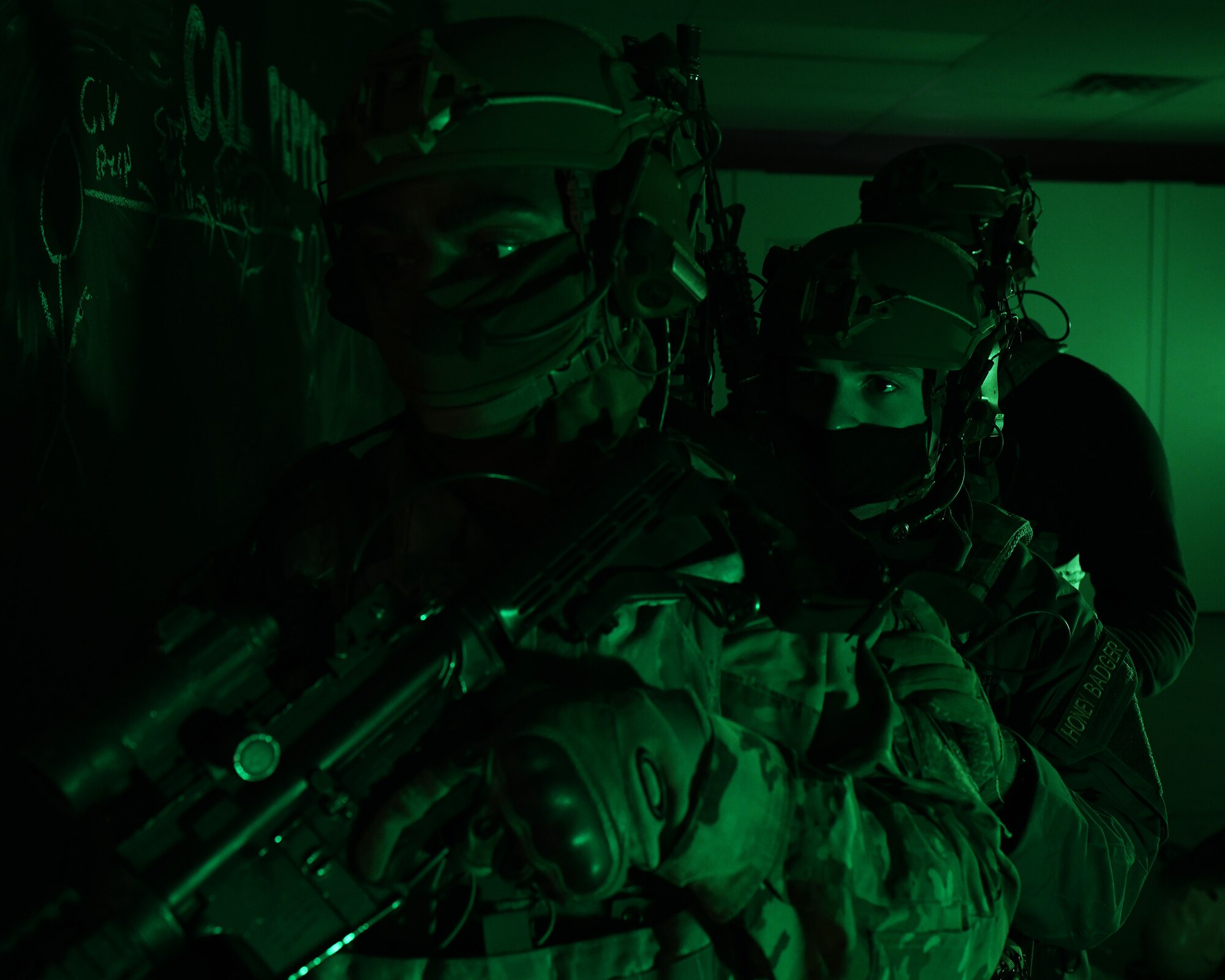 Airmen from the 460th Security Forces Squadron stand guard at a door during a training exercise at Buckley Air Force Base, Colo., Feb. 17, 2021. During the training, the Defenders refreshed their Tactical Combat Casualty Care with the Aurora Special Weapons and Tactics Team before going through the shoot house to apply what they learned. (U.S. Space Force photo by Airman 1st Class Haley N. Blevins)