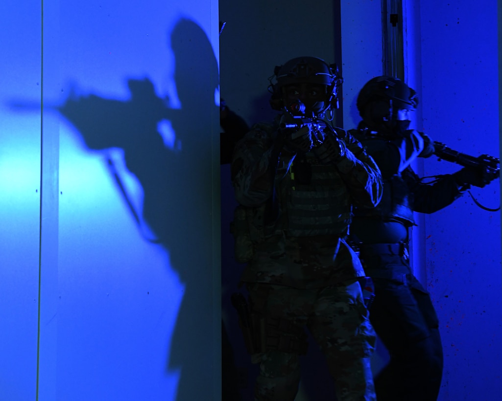 Airmen from the 460th Security Forces Squadron sweep a room in the shoot house at Buckley Air Force Base, Colo., Feb. 17, 2021. The 460th SFS ran through multiple scenarios in the shoot house alongside the Aurora Special Weapons and Tactic Team. (U.S. Space Force photo by Airman 1st Class Haley N. Blevins)