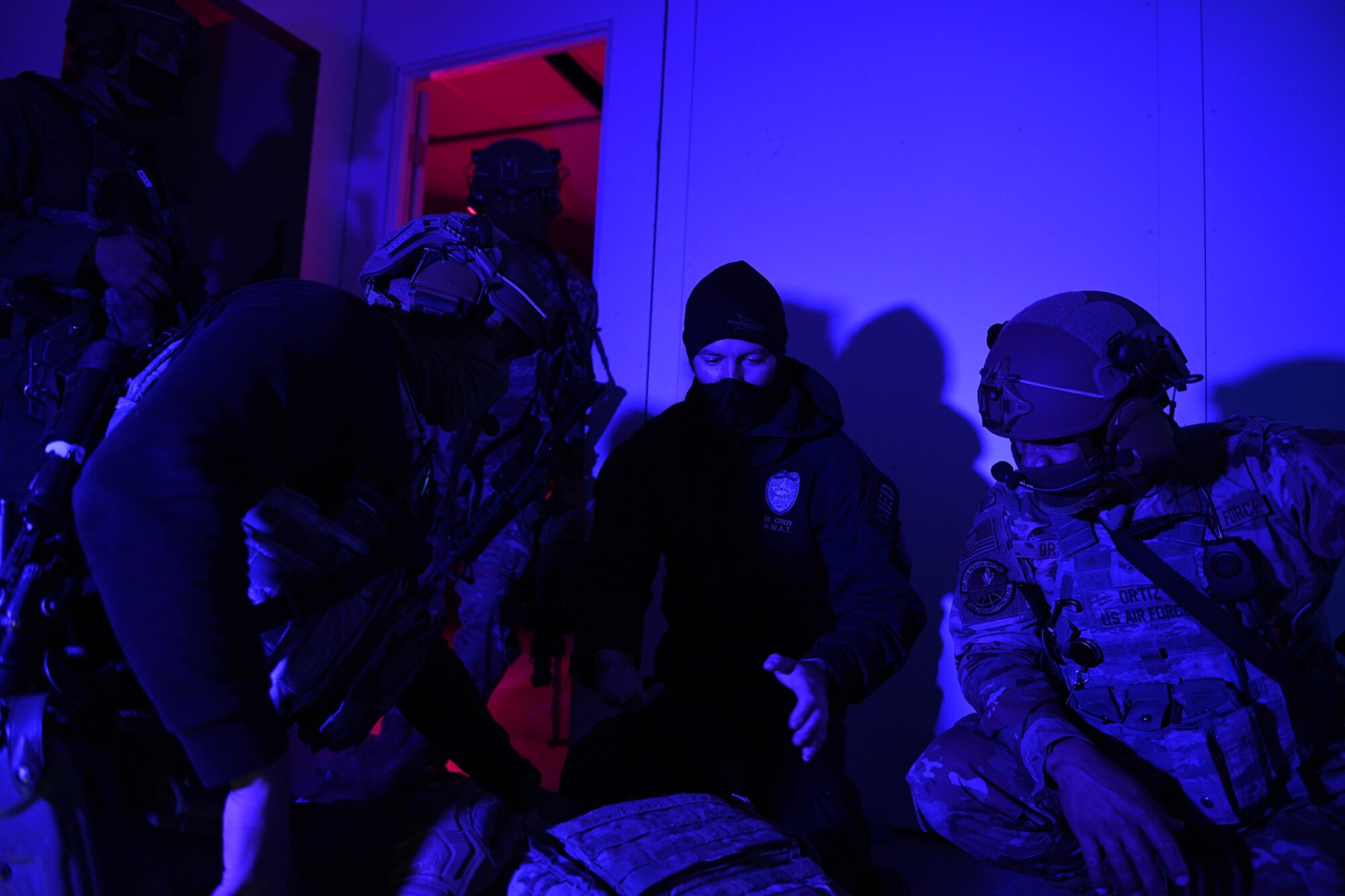 An officer from the Aurora Special Weapons and Tactics Team instructs members from the 460th Security Forces Squadron during a joint exercise at Buckley Air Force Base, Colo., Feb. 17. 2021. During the training, the Defenders refreshed their Tactical Combat Casualty Care with the Aurora SWAT team before going through the shoot house to apply what they learned. (U.S. Space Force photo by Airman 1st Class Haley N. Blevins)