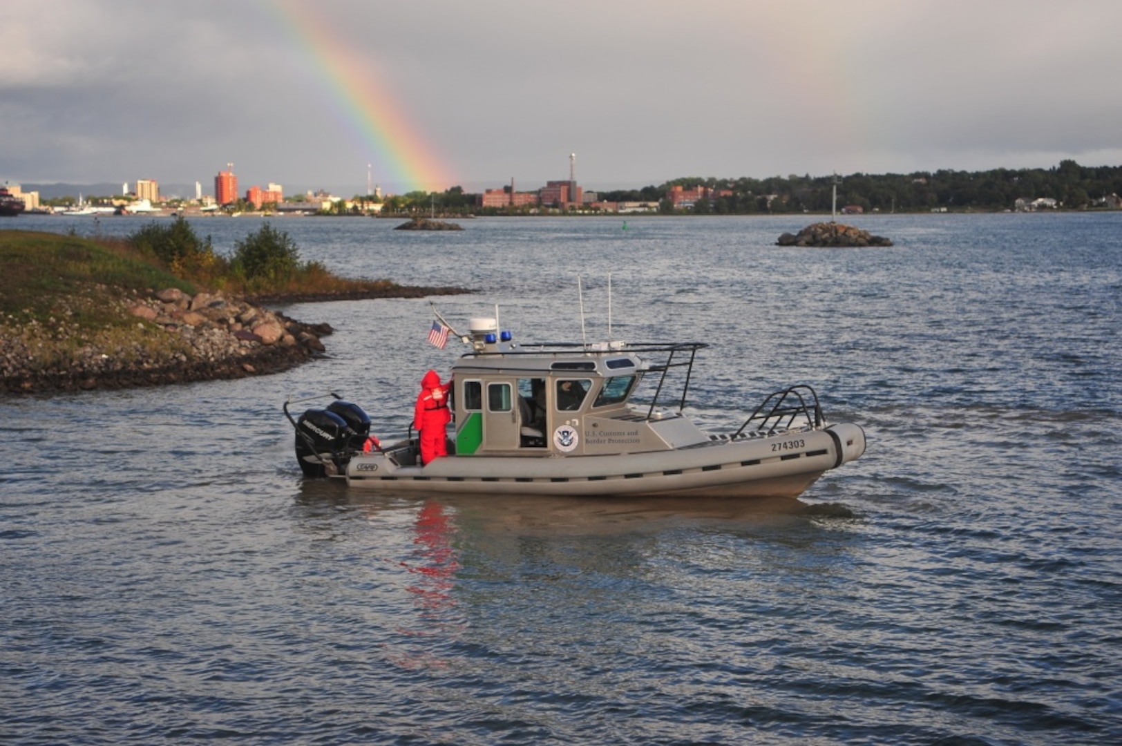 SAULT STE. MARIE, Mich. - A U.S. Coast Guardsman stands on the stern of a U.S. Customs and Border Protection vessel after the boat was launched to provide a security zone around the Soo Locks in the St. Marys River near Sault Ste. Marie, Mich., as part of a maritime security exercise there Sept. 15, 2011. Representatives from various federal, state and local and Canadian agencies, tribes, and stakeholders participated in the exercise, built around a scenario involving a bomb placed at the Soo Locks and designed to strengthen partnerships among all those involved. (U.S. Coast Guard photo by Petty Officer 2nd Class Lauren Jorgensen)