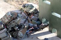 A Soldier from the 2-506, 101st Airborne Division uses the Enhanced Night Vision Goggle (ENVG-B), Nett Warrior, and Family of Weapons Sight – Individual (FWS-I) during a live fire test event during a Soldier Touchpoint at Aberdeen Proving Ground, MD in February 2021. The FWS-I optic feeds the view of the weapon sight into the ENVG-B goggle display, which allows the Soldier to engage the target while behind cover.