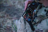 A Soldier from the 2-506, 101st Airborne Division checks his Nett Warrior end user device (EUD) during a full mission test event at a Soldier Touchpoint at Aberdeen Proving Ground, MD in February 2021.