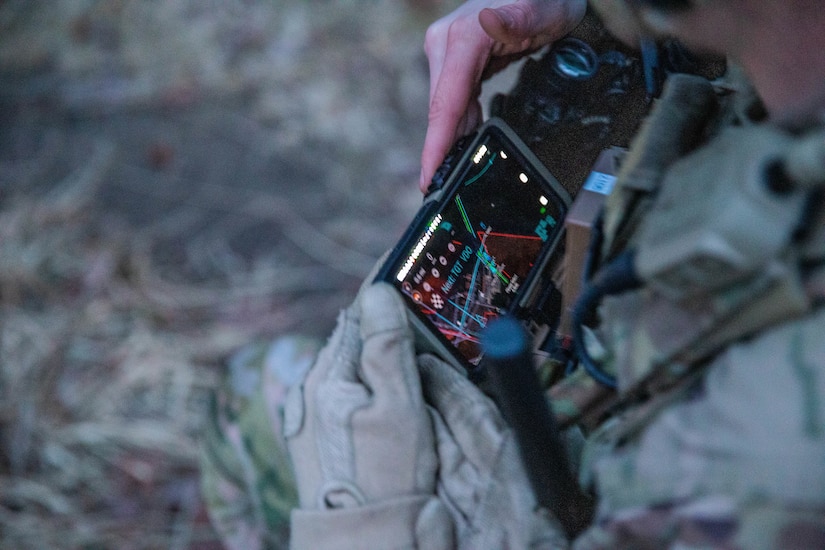 A Soldier from the 2-506, 101st Airborne Division checks his Nett Warrior end user device (EUD) during a full mission test event at a Soldier Touchpoint at Aberdeen Proving Ground, MD in February 2021.