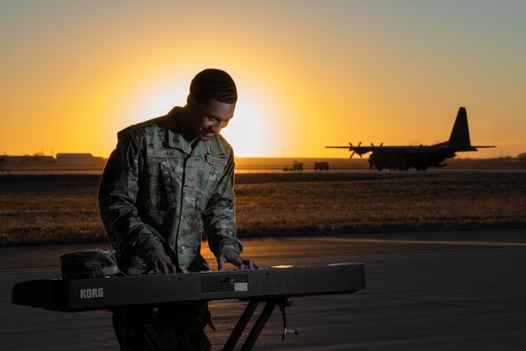 Airman 1st Class Josiah Beecham, 27th Special Operations Aircraft Maintenance Squadron electrical and environmental apprentice, plays the piano on the flightline at Cannon AFB, N.M., February 25th, 2021. Beecham prefers to spend his free time making music as it gives him a creative outlet and a way to engage his mind outside of work. (U.S. Air Force photo by Airman 1st Class Christopher Storer)