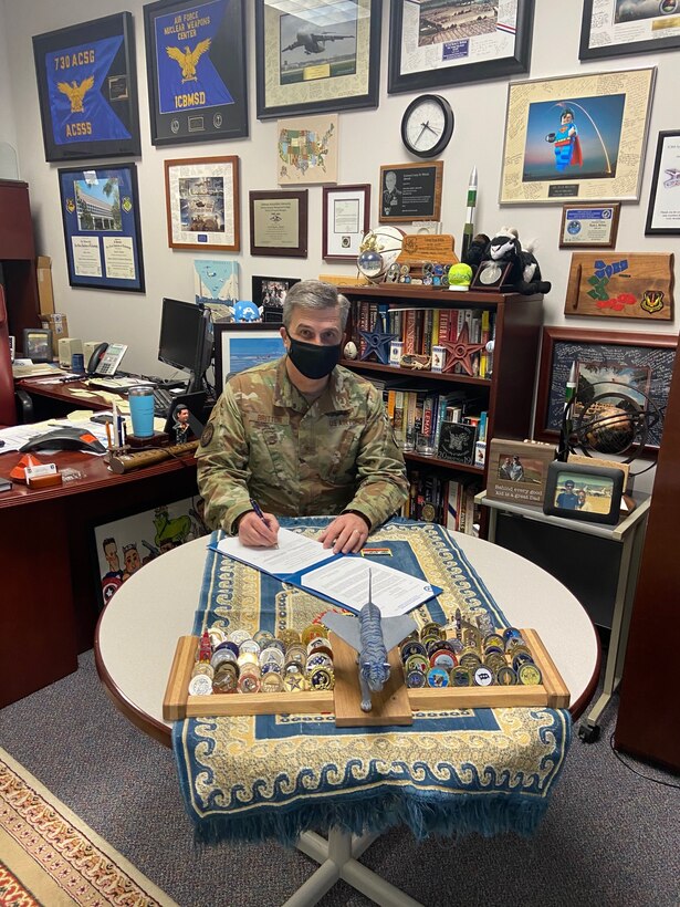 Brig. Gen. Ryan Britton, Program Executive Officer for the Presidential and Executive Airlift Directorate and Vector Prime champion, signs document establishing a sponsorship agreement with the Arnold Engineering Development Complex. (Courtesy photo)