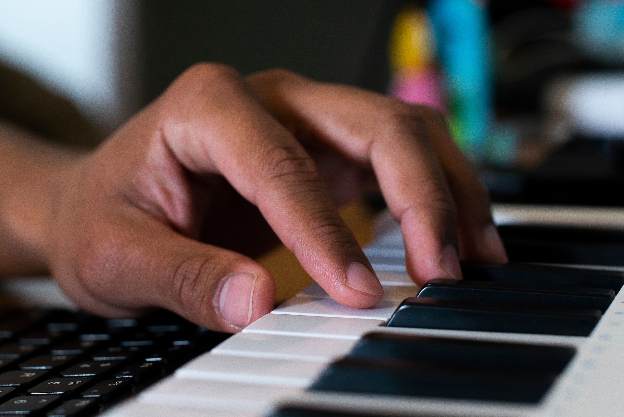 Airman 1st Class Josiah Beecham, 27th Special Operations Aircraft Maintenance Squadron electrical and environmental apprentice, plays notes on his keyboard connected to his personal laptop. Keyboards can emulate a multitude of instrument sounds, providing a diverse selection of sounds for artists to use in their work. (U.S. Air Force photo by Airman 1st Class Christopher Storer)