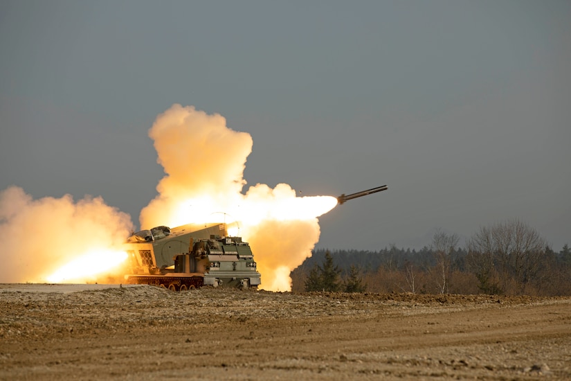 A rocket launches in a field.