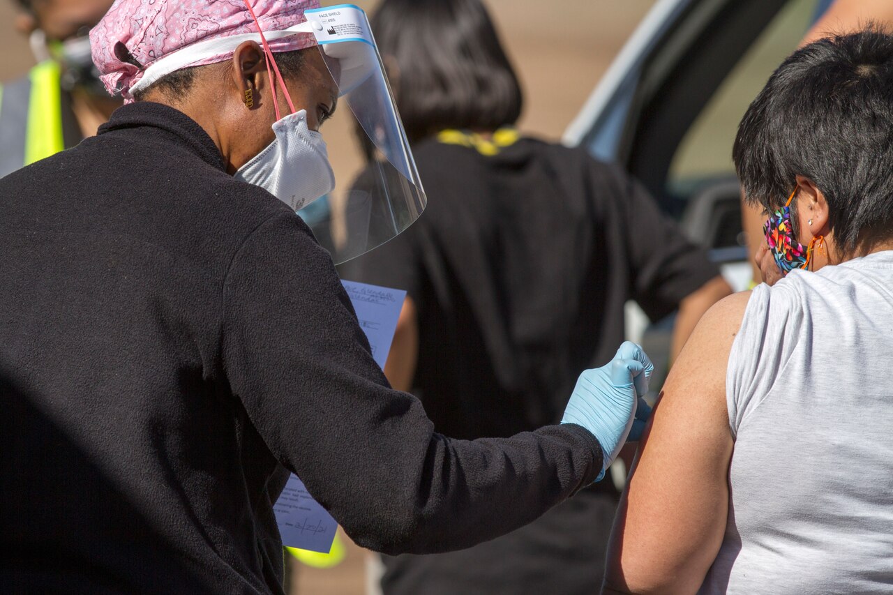 A Native American community member receives a vaccination.