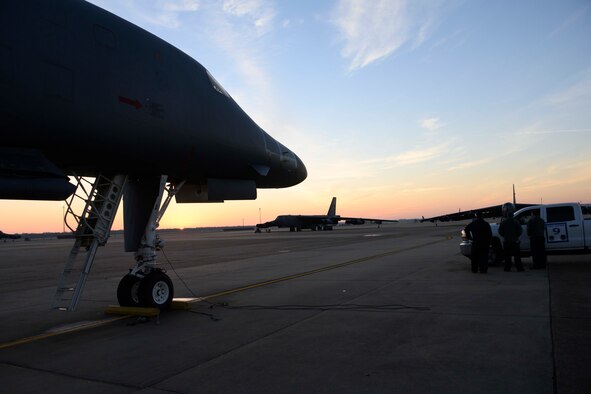 Silhouette of jets on a flightline.