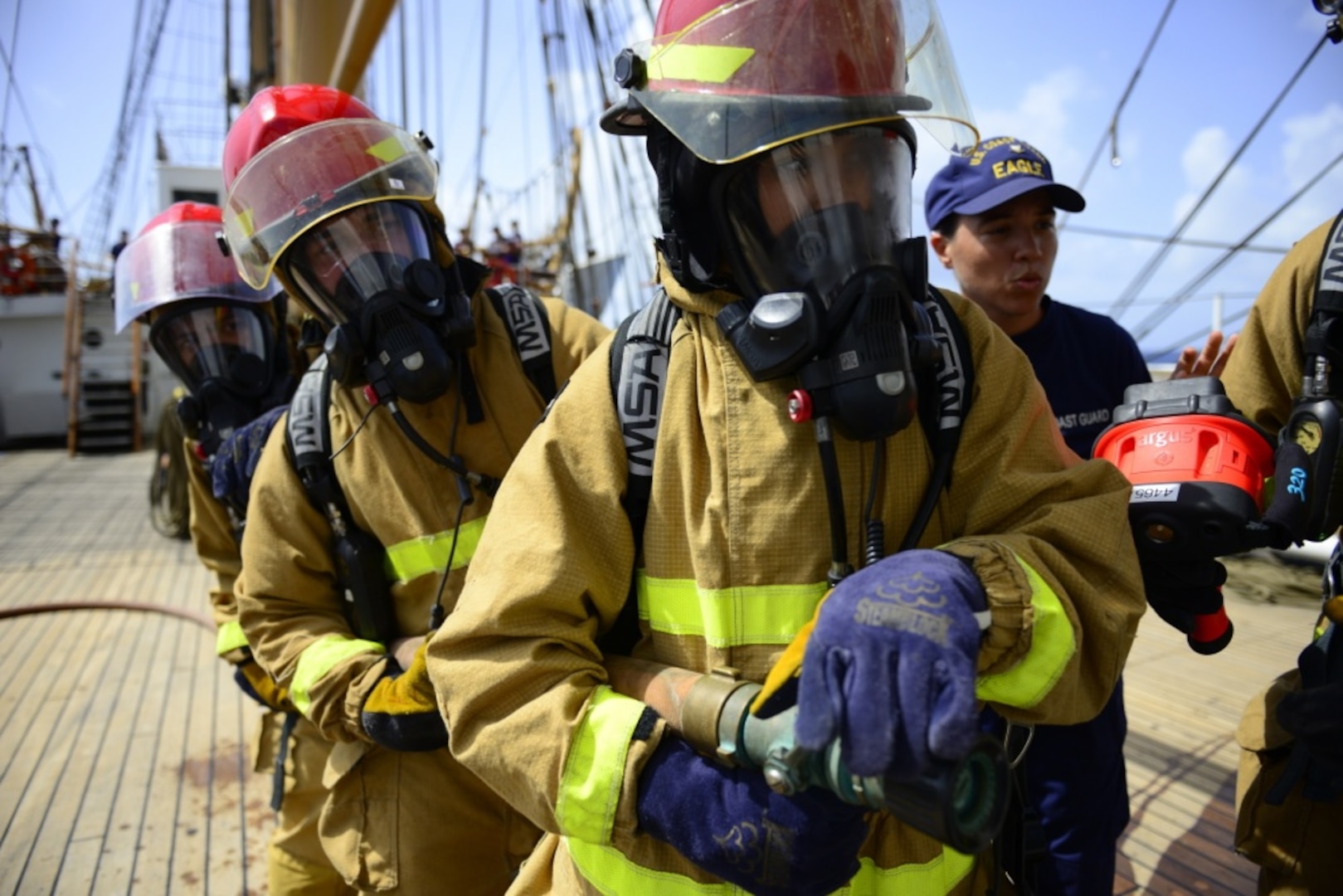 The crew and Coast Guard Academy cadets assigned to Coast Guard Cutter Eagle test their newly acquired fire fighting skills in the Caribbean Sea on June 7, 2018. The 295-foot Barque Eagle is the flagship of the U.S. Coast Guard and serves as a training vessel for cadets at the Coast Guard Academy. (U.S. Coast Guard photo by Petty Officer 3rd Class Johanna Strickland/Released)