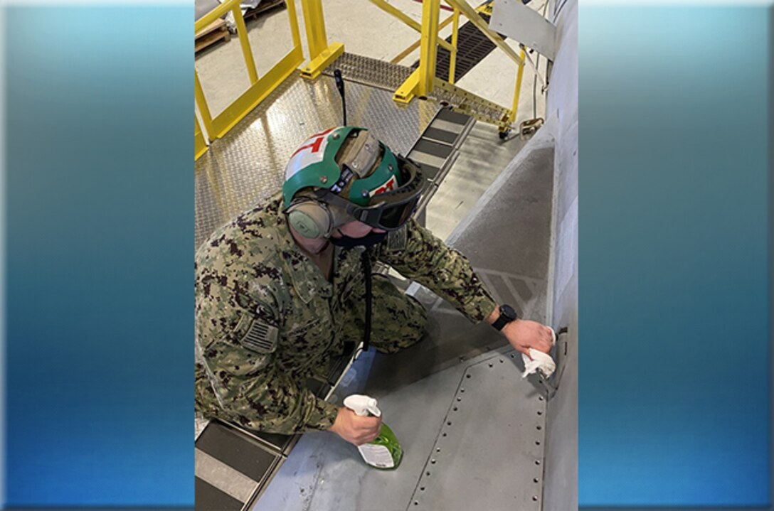 Airman cleans aircraft with disinfectant