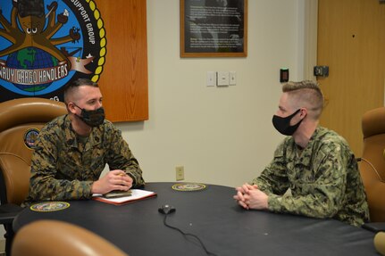 Master Sgt. Robert L. Gallup, Jr speaks with Petty Officer 3rd Class Cullen G. Turner at Navy Expeditionary Logistics Support Group’s (NAVELSG) headquarters building on Feb. 24.