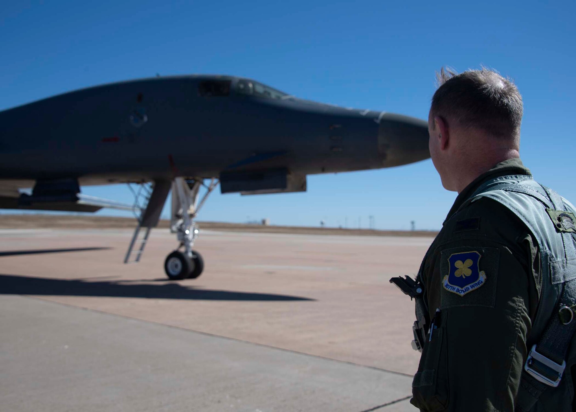 Airman looks at a B-1.