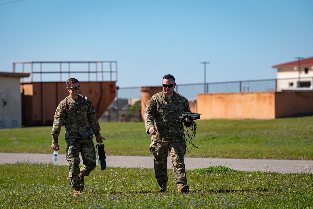 A photo of Airmen carrying cables