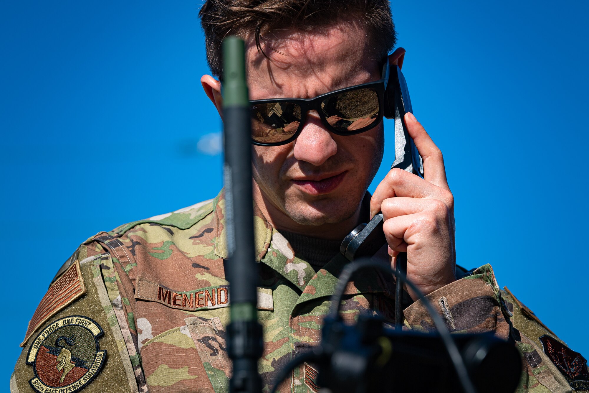 A photo of an Airman using a radio