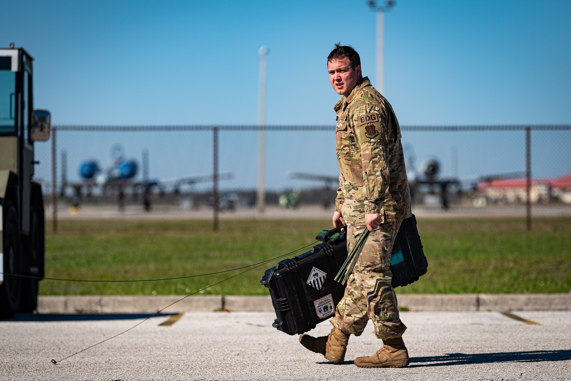 A photo of an Airman adjusting an antenna