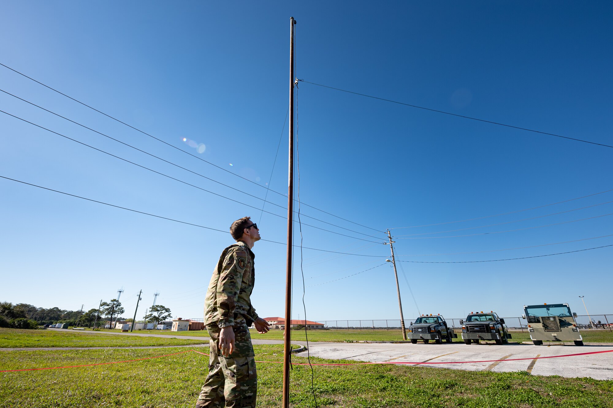 A photo of an Airman examining an antenna