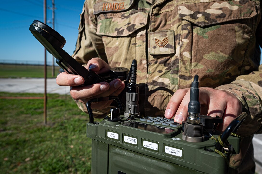 A photo of an Airman using a radio