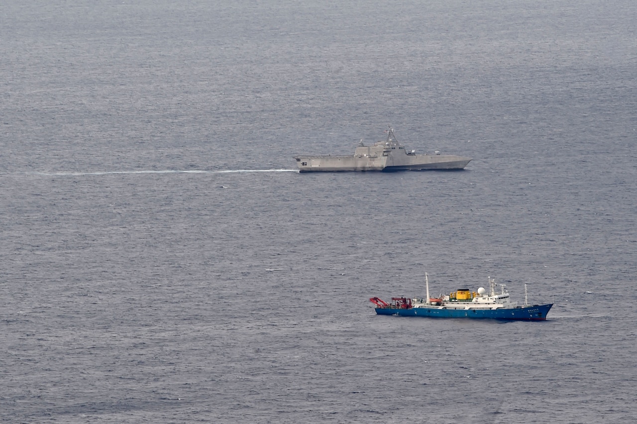 Two ships maneuver at sea.