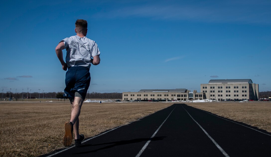 Air Force Uniform Office member 2nd Lt. Maverick Wilhite puts parts of the updated Air Force physical training (PT) uniform through their paces at Wright-Patterson Air Force Base, Ohio, Feb. 25, 2021. The Air Force Uniform Office is part of the Human System's Division in the Air Force Life Cycle Management Center's Agile Combat Support Directorate. This is the first update to the PT uniform in more than 16 years, and over 150 Airmen participated in testing the new gear. The new ensemble currently consists of a jacket, a pair of pants, a T-shirt and two types of shorts; a lined runner's short and a longer unlined multipurpose short. A long sleeve t-shirt and a hoodie are in development. The ensemble features improved fabrics that are softer and quick drying, and have antimicrobial technology, which helps with moisture and odor control. The new uniform items are entering the production phase and will be available to Airmen sometime in 2022. (U.S. Air Force photo by Jim Varhegyi)