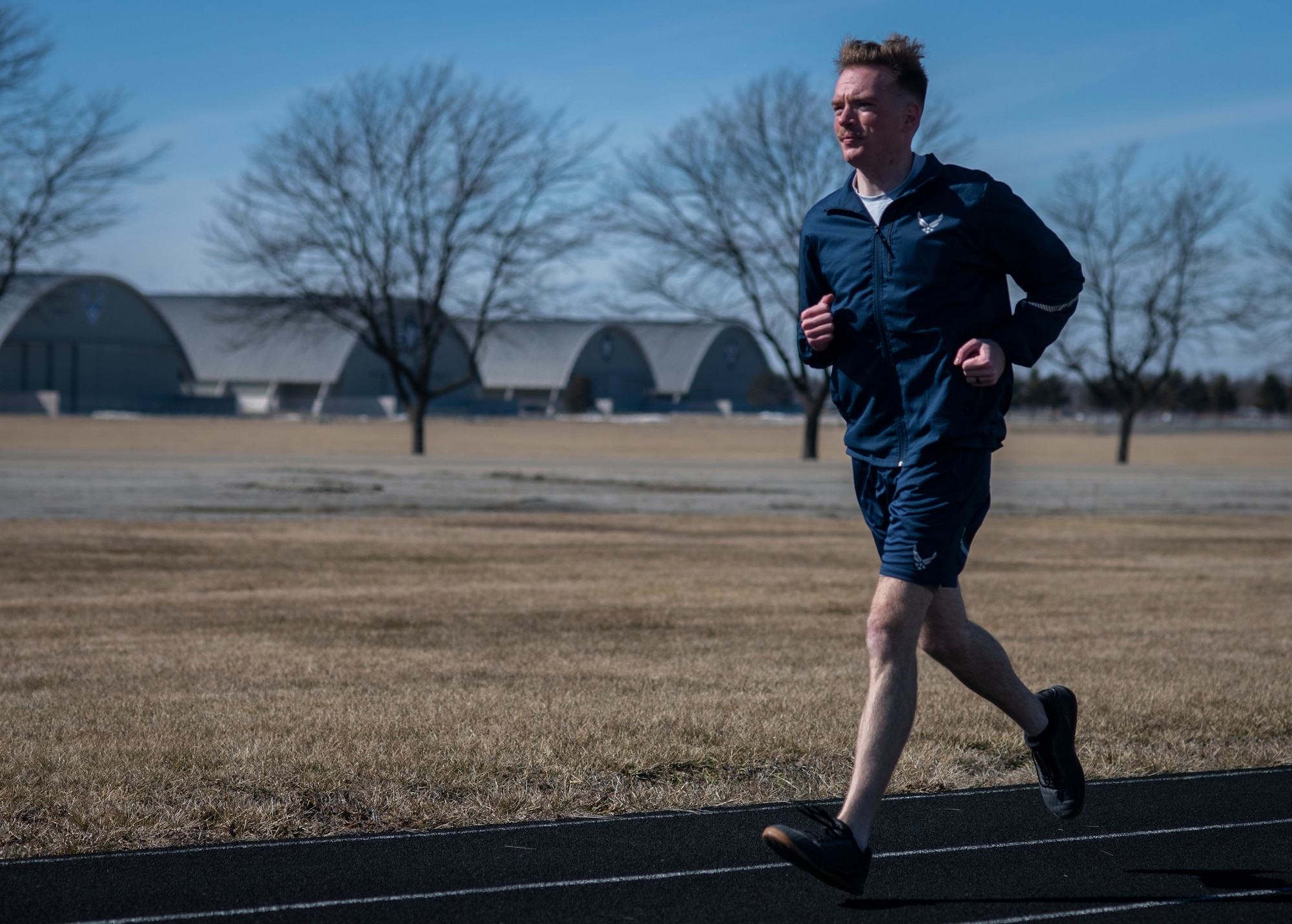 Air Force Uniform Office member 2nd Lt. Maverick Wilhite puts parts of the updated Air Force physical training (PT) uniform through their paces at Wright-Patterson Air Force Base, Ohio, Feb. 25, 2021. The Air Force Uniform Office is part of the Human System's Division in the Air Force Life Cycle Management Center's Agile Combat Support Directorate. This is the first update to the PT uniform in more than 16 years, and over 150 Airmen participated in testing the new gear. The new ensemble currently consists of a jacket, a pair of pants, a T-shirt and two types of shorts; a lined runner's short and a longer unlined multipurpose short. A long sleeve t-shirt and a hoodie are in development. The ensemble features improved fabrics that are softer and quick drying, and have antimicrobial technology, which helps with moisture and odor control. The new uniform items are entering the production phase and will be available to Airmen sometime in 2022. (U.S. Air Force photo by Jim Varhegyi)