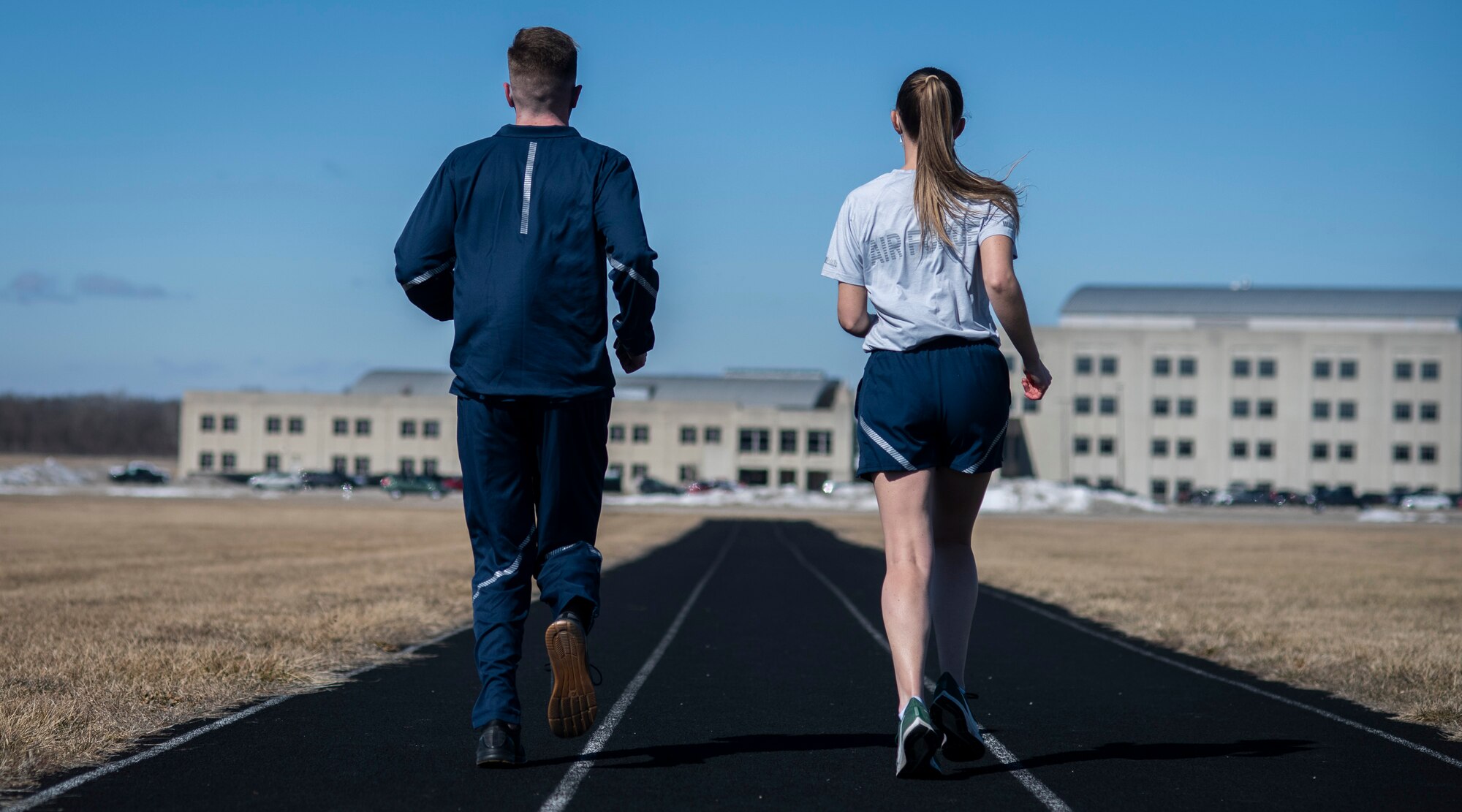 Air Force Uniform Office members 1st Lt. Avery Thomson and 2nd Lt. Maverick Wilhite put updated versions of the Air Force physical training (PT) uniform through their paces at Wright-Patterson Air Force Base, Ohio, Feb. 25, 2021.  The Air Force Uniform Office is part of the Human System's Division in the Air Force Life Cycle Management Center's Agile Combat Support Directorate. This is the first update to the PT uniform in more than 16 years, and over 150 Airmen participated in testing the new gear. The new ensemble currently consists of a jacket, a pair of pants, a T-shirt and two types of shorts; a lined runner's short and a longer unlined multipurpose short. A long sleeve t-shirt and a hoodie are in development. The ensemble features improved fabrics that are softer and quick drying, and have antimicrobial technology, which helps with moisture and odor control. The new uniform items are entering the production phase and will be available to Airmen sometime in 2022. (U.S. Air Force photo by Jim Varhegyi)