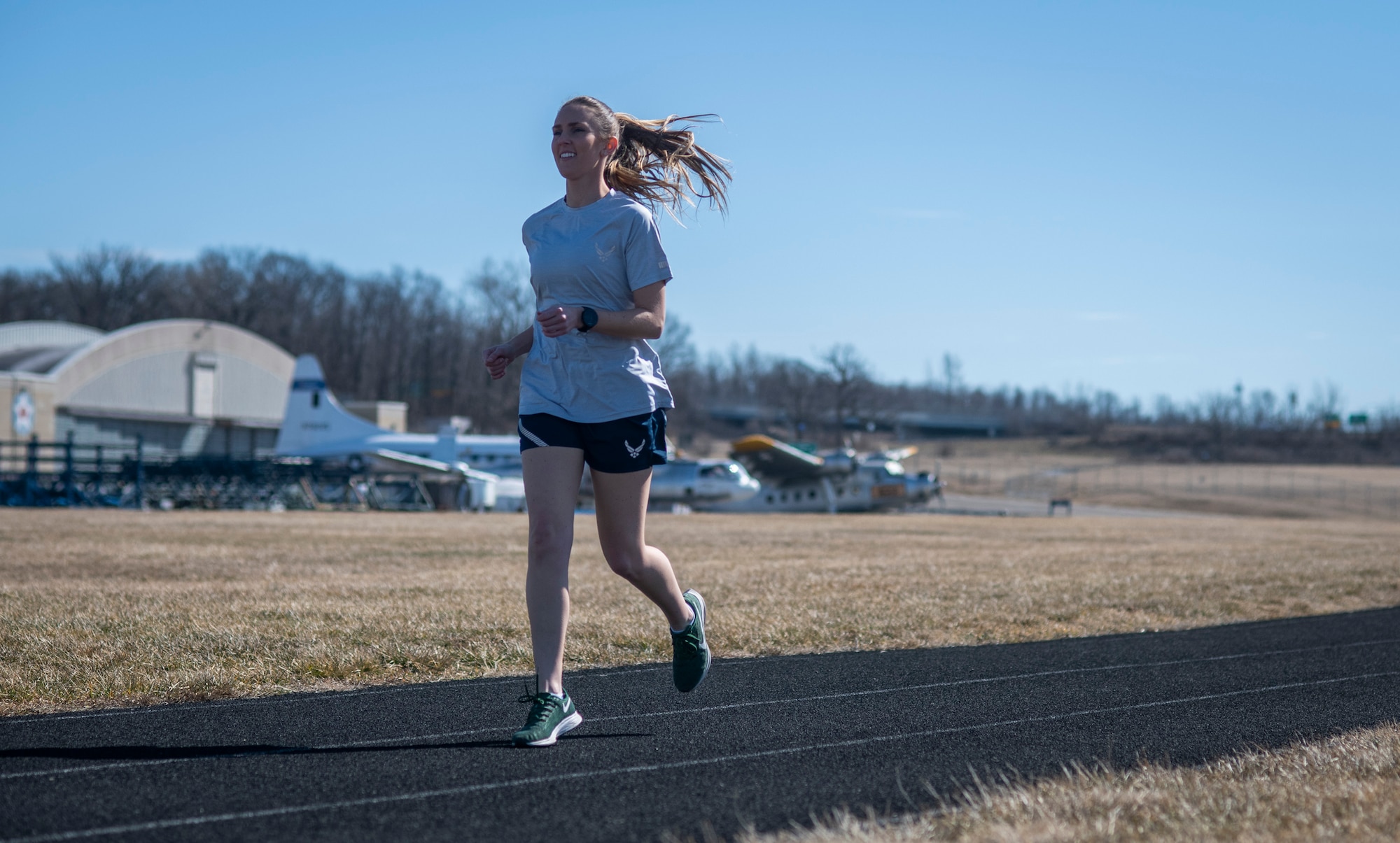 Air Force Uniform Office member 1st Lt. Avery Thomson puts parts of the updated Air Force physical training (PT) uniform through their paces at Wright-Patterson Air Force Base, Ohio, Feb. 25, 2021. The Air Force Uniform Office is part of the Human System's Division in the Air Force Life Cycle Management Center's Agile Combat Support Directorate. This is the first update to the PT uniform in more than 16 years, and over 150 Airmen participated in testing the new gear. The new ensemble currently consists of a jacket, a pair of pants, a T-shirt and two types of shorts; a lined runners short and a longer unlined multipurpose short. A long sleeve t-shirt and a hoodie are in development. The ensemble features improved fabrics that are softer and quick drying, and have antimicrobial technology, which helps with moisture and odor control. The new uniform items are entering the production phase and will be available to Airmen sometime in 2022. (U.S. Air Force photo by Jim Varhegyi)