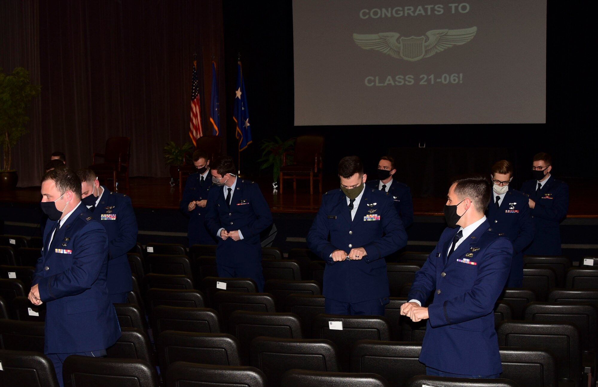 Graduates from the Specialized Undergraduate Pilot Training class 21-06, pilots break their first pair of wings, during their graduation ceremony, Feb. 26, 2021, on Columbus Air Force Base, Miss. Per tradition, pilots will keep one half of the broken wings and give the second half to a loved one. (U.S. Air Force photo by Melissa Duncan-Doublin)