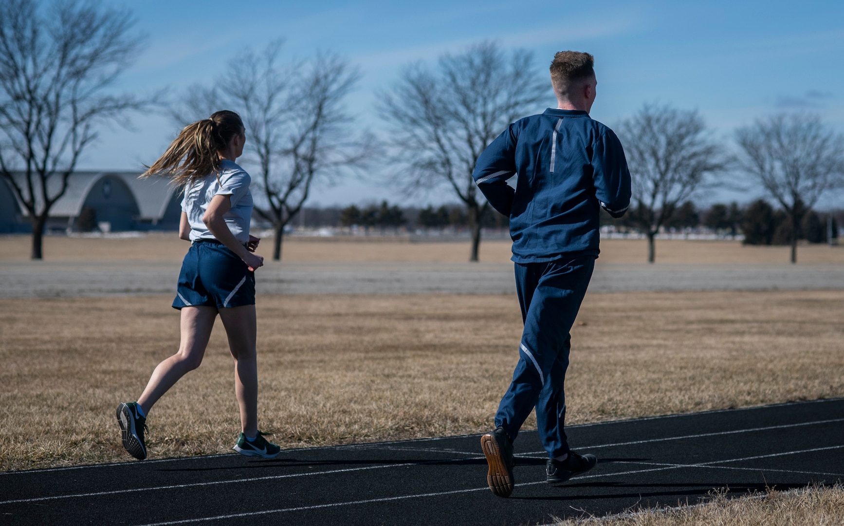 Air Force Uniform Office members 1st Lt. Avery Thompson and 2nd Lt. Maverick Wilhite put updated versions of the Air Force phyisical training (PT) uniform through their paces at Wright-Patterson Air Force Base, Ohio, Feb. 25, 2021.  The Air Force Uniform Office is part of the Human System's Division in the Air Force Life Cycle Management Center's Agile Combat Support Directorate. This is the first update to the PT uniform in more than 16 years, and over 150 Airmen participated in testing the new gear. The new ensemble currently consists of a jacket, a pair of pants, a T-shirt and two types of shorts; a lined runner's short and a longer unlined multipurpose short. A long sleeve t-shirt and a hoodie are in development. The ensemble features improved fabrics that are softer and quick drying, and have antimicrobial technology, which helps with moisture and odor control. The new uniform items are entering the production phase and will be available to Airmen sometime in 2022. (U.S. Air Force photo by Jim Varhegyi)