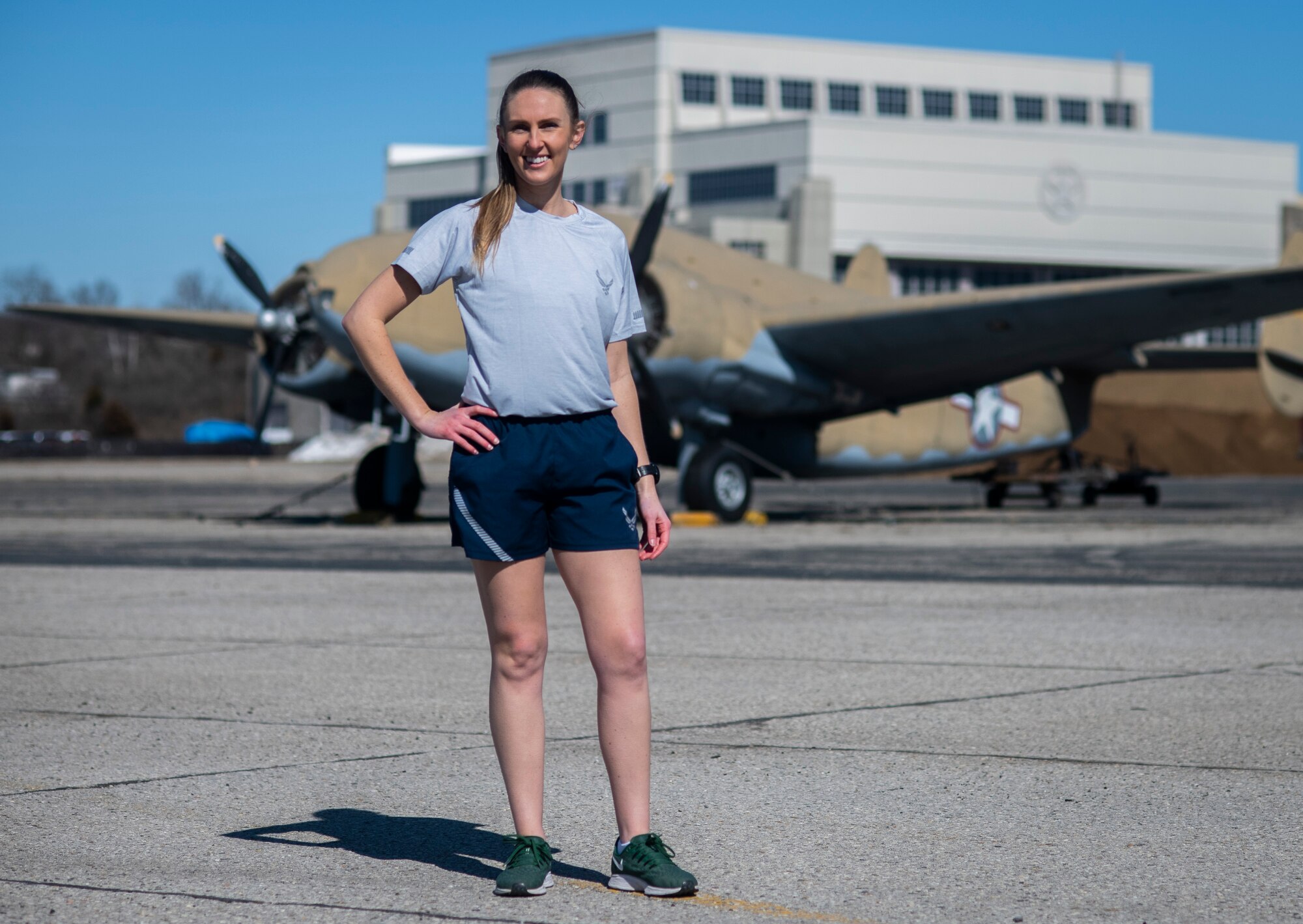 Air Force Uniform Office member 1st Lt. Avery Thomson wears the updated Air Force physical training (PT) uniform t-shirt and running shorts at Wright-Patterson Air Force Base, Ohio, Feb. 25, 2021.  The Air Force Uniform Office is part of the Human System's Division in the Air Force Life Cycle Management Center's Agile Combat Support Directorate. This is the first update to the PT uniform in more than 16 years, and over 150 Airmen participated in testing the new gear. The new ensemble currently consists of a jacket, a pair of pants, a T-shirt and two types of shorts; a lined runner's short and a longer unlined multipurpose short. A long sleeve t-shirt and a hoodie in development. The ensemble features improved fabrics that are softer and quick drying, and have antimicrobial technology, which  helps with moisture and odor control. The new uniform items are entering the production phase and will be available to Airmen sometime in 2022. (U.S. Air Force photo by Jim Varhegyi)