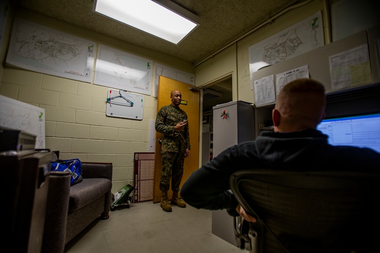 U.S. Marine Corps Sgt. Jamal Washington, an assistant contracting officer representative with the bulk fuel office with Headquarters and Support (H&S) Battalion, Marine Corps Installations Pacific – Marine Corps Base Camp Butler, speaks to Staff Sgt. Bradley Hoffman, the staff noncommissioned officer in charge contracting officer representative with the bulk fuel office, H&S Battalion at a defense fuel supply point (DFSP) on Camp Foster, Okinawa, Japan, Jan. 14, 2021. A DFSP on Okinawa allows III Marine Expeditionary Force to stay ready at a moment’s notice. Bulk fuel supports all types of transportation fuel for the variety of U.S. military vehicles on Okinawa. Washington is a native of Charleston, South Carolina. Hoffman is a native of Bethlehem, Pennsylvania. (U.S. Marine Corps photo by Lance Cpl. Shelby A. Karr)