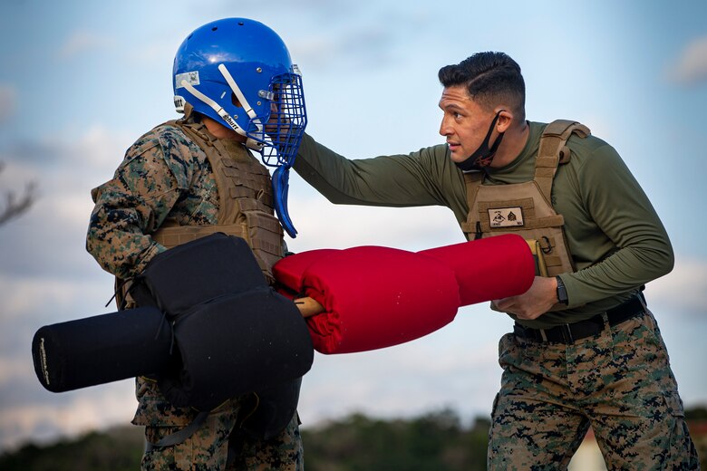 U.S. Marine Corps Sgt. Avery Luengo, the platoon sergeant for G-6 Customer Service Branch, ensures proper personal protective equipment prior to using pugil sticks during a Marine Corps Martial Arts Program course on Camp Foster, Okinawa, Japan, Feb. 4, 2020. Luengo remains proactive with his Marines and his own duties by being a force multiplier and exceeding the standard of a noncommissioned officer by earning several awards and certifications through various demanding billets. Luengo is a native of Reynosa, Mexico, and McAllen, Texas. (U.S. Marine Corps photo by Cpl. Karis Mattingly)