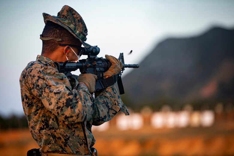Lance Cpl. Michael Hendricks, a postal clerk with the Camp Foster Post Office, fires down range at his target on Camp Schwab, Okinawa, Japan, Feb. 2, 2020. Once a year, Marines are required to shoot on the known distance course of fire, tables one and two. Upon completion, Marines are awarded a score of marksmanship, sharpshooter or expert. Hendricks is a native of Brooklyn, New York. (U.S. Marine Corps photo by Cpl. Karis Mattingly)