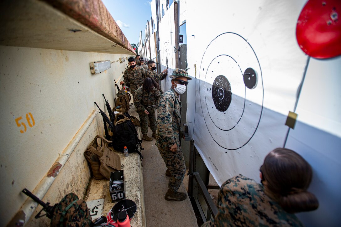 U.S. Marines with Marine Corps Installation Pacific- Camp Smedley D. Butler, mark targets signifying where a Marine has shot on Camp Schwab, Okinawa, Japan, Feb. 2, 2020. Once a year, Marines are required to shoot on the known distance course of fire, tables one and two. Upon completion, Marines are awarded a score of marksmanship, sharpshooter or expert. (U.S. Marine Corps photo by Cpl. Karis Mattingly)