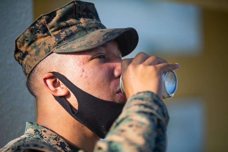 U.S. Marine Corps Pfc. Corbin Russell, a postal clerk with 3rd Supply Battalion, 3rd Marine Logistics Group, drinks a latte provided by the United Service Organizations (USO) Camp Foster representatives at the U.S. Naval Hospital Okinawa on Camp Foster, Okinawa, Japan, Feb. 2, 2020. USO representatives offered service members the chance to relax and rejuvenate by providing drinks, snacks and entertainment as they waited to receive the COVID-19 vaccine. Russell is a native of Paris, Texas. (U.S. Marine Corps photo by Lance Cpl. Alex Fairchild)