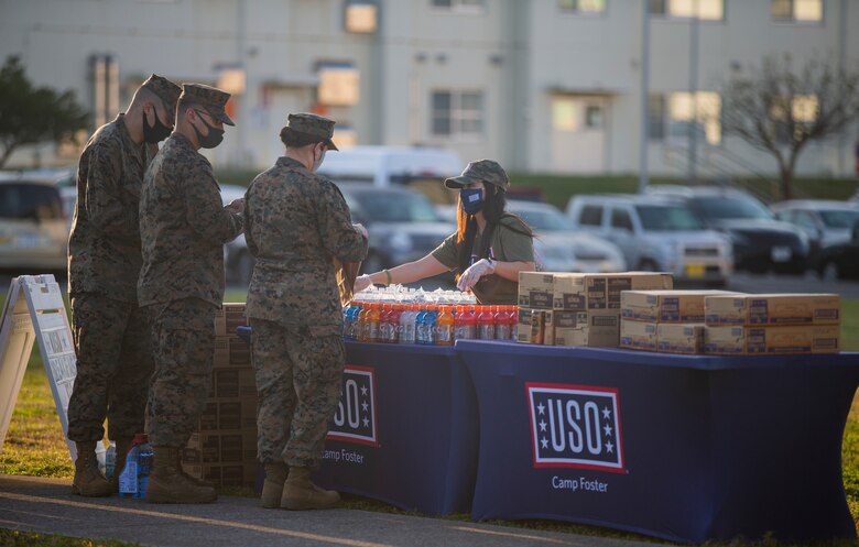 Angela Tom, the United Service Organizations (USO) Camp Foster Center Manager, provides Marines with drinks and refreshment at the U.S. Naval Hospital Okinawa on Camp Foster, Okinawa, Japan, Feb. 2, 2020. USO representatives offered service members the chance to relax and rejuvenate by providing drinks, snacks and entertainment as they waited to receive the COVID-19 vaccine. Tom is a native of San Francisco, California. (U.S. Marine Corps photo by Lance Cpl. Alex Fairchild)