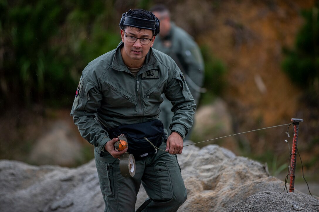 U.S. Marine Corps Sgt. Julian Mora, an explosive ordnance disposal (EOD) technician with Headquarters and Support Battalion, Marine Corps Installations Pacific – Marine Corps Base Camp Smedley D. Butler, prepares a M67 hand grenade during a standoff munition disruption (SMUD) range on Camp Hansen, Okinawa, Japan, Jan. 8, 2020. SMUD is a technique used by EOD technicians where they utilize a service weapon to disrupt and neutralize munition from a standoff distance in order to achieve a low-order detonation. Mora is a native of Kissimmee, Florida. (U.S. Marine Corps photo by Cpl. Brennan J. Beauton)