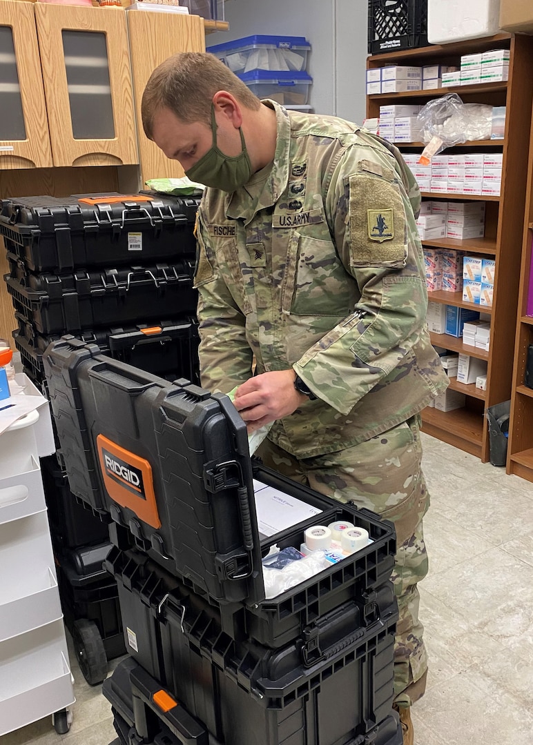 Sgt. Michael Fischer, a combat medic assigned to the Nebraska Army National Guard's 92nd Troop Command, inventories and packs medical supplies at the West Central District Health Department office in North Platte, Nebraska, Feb. 24, 2021. Fischer was preparing for a mass vaccination clinic the next day for workers at Bailey Yard, the world's largest railroad classification yard.