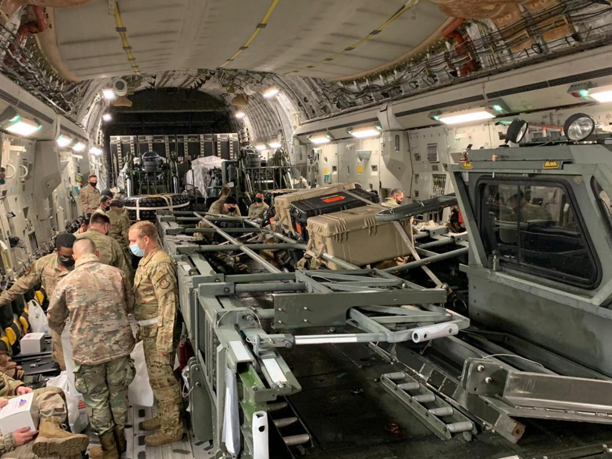 U.S. Air Force Airmen assigned to the 435th Air Expeditionary Wing stand in a U.S Air Force C-130J Super Hercules aircraft during an asset repositioning during Operation Octave Quartz