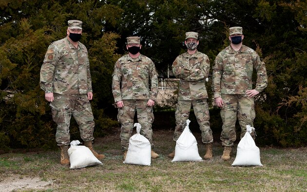 Senior Master Sgts. Daniel Drake, Brian Nash, Ian Gardner, Master Sgt. Kevin Merrill and Todd Gardner (not pictured) volunteered to place sand bags in advance of potential flooding at St. Joseph’s Free Will Baptist, February 19. 2021