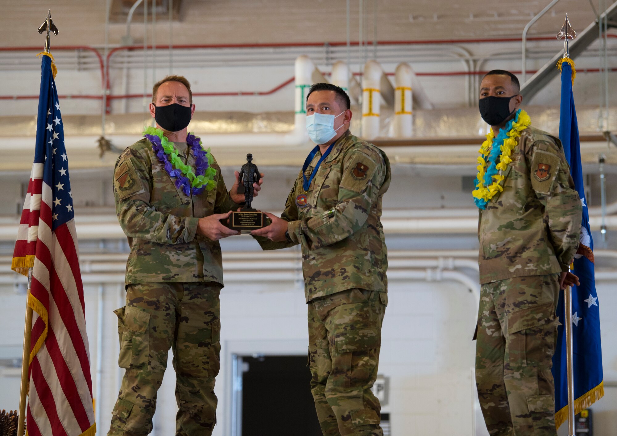 Col. Thomas Preston, left, 49th Maintenance Group commander, presents Master Sgt. Jose Gonzalez, 49th Aircraft Maintenance Squadron production superintendent Maintenance Professional of the Year award during the 2020 Maintenance Professional of the Year Awards ceremony, Feb. 26, 2021, on Holloman Air Force Base, New Mexico. The original maintenance professional award was established in 1979 to recognize outstanding performance of direct, sortie-producing maintenance specialists. (U.S. Air Force photo by Airman 1st Class Jessica Sanchez)
