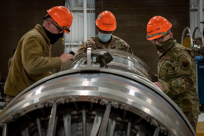 Aerospace propulsion technicians from the 4th Component Maintenance Squadron work on an F-15E Strike Eagle engine at Seymour Johnson Air Force Base, North Carolina, Feb. 2, 2021.