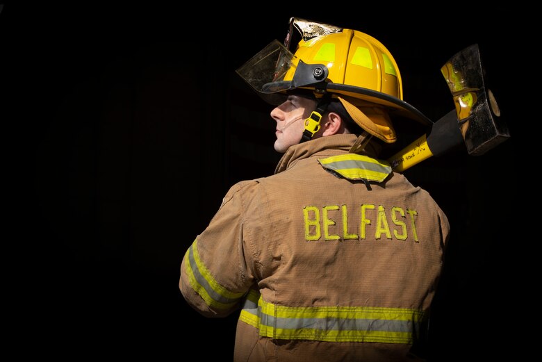 Senior Airman Derrick Radzieski, 4th Component Maintenance Squadron aerospace propulsion technician, carries an axe at Seymour Johnson Air Force Base, North Carolina, Feb. 24, 2021.