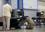 Personnel from Brooke Army Medical Center’s Information Management Division connect one of more than 40 computers at the Joint Base San Antonio-Fort Sam Houston COVID-19 Vaccine Site.