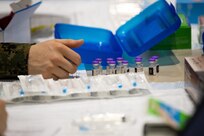 A U.S. Navy Sailor, assigned to Combat Logistics Battalion 22 (CLB-22), prepares COVID-19 vaccines during the setup of the state-run, federally-supported COVID-19 Community Vaccination Center at the Pennsylvania Convention Center in Philadelphia, March 1, 2021.
