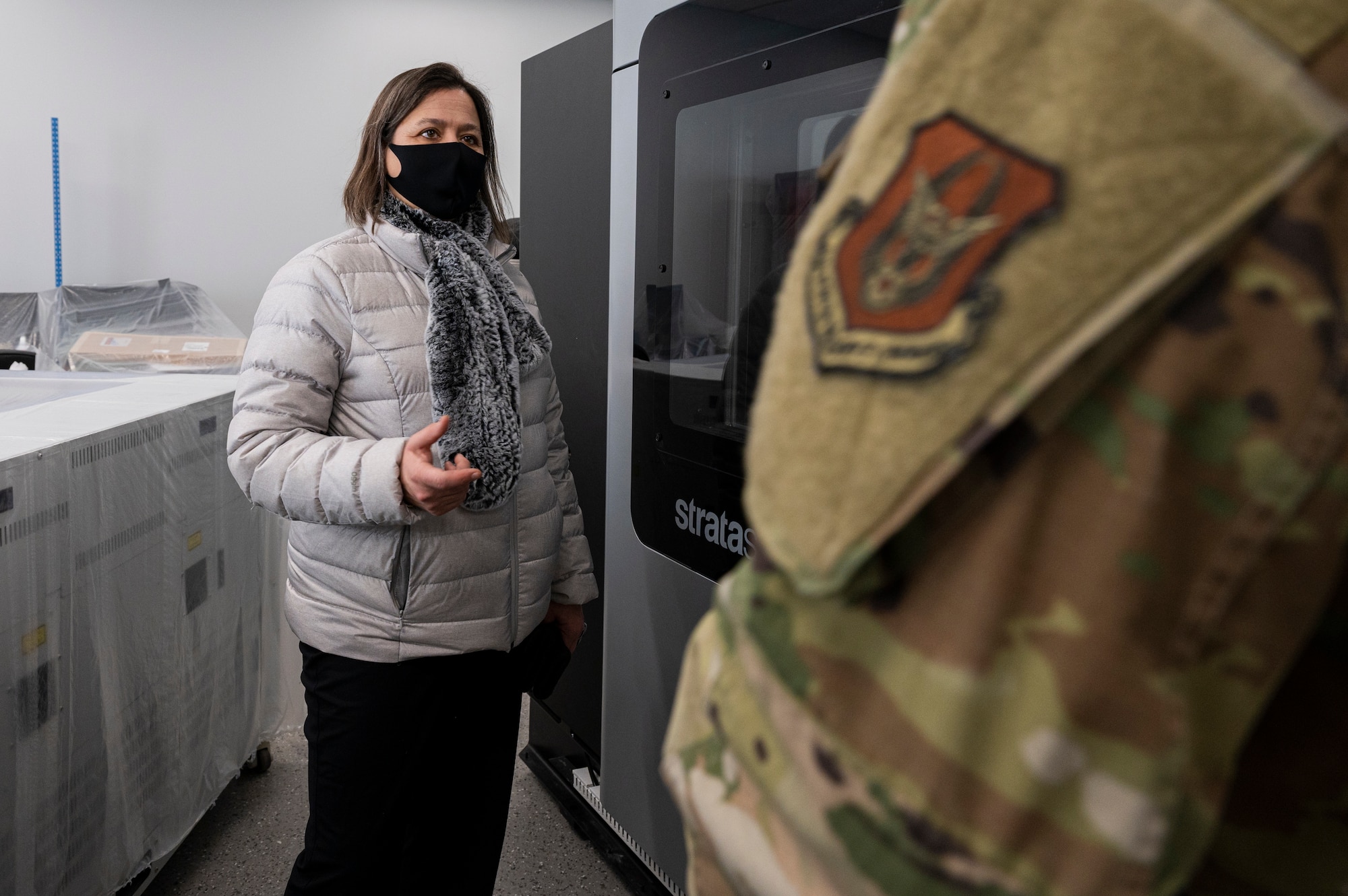 Pennsylvania State Representative Valerie Gaydos speaks with a member of the 911th Airlift Wing at the Pittsburgh International Airport Air Reserve Station, Pennsylvania, Feb. 19, 2021.