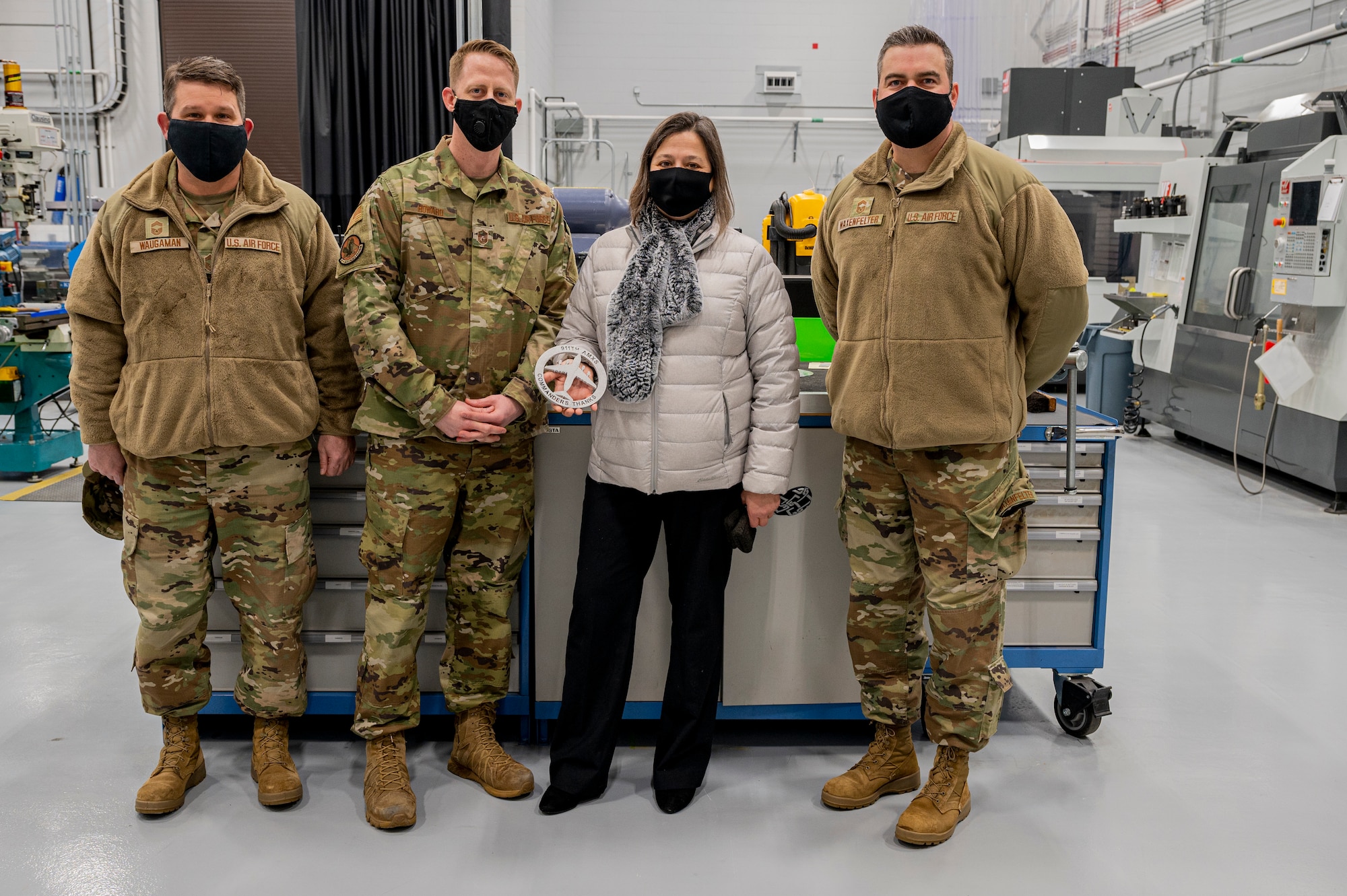 Pennsylvania State Representative Valerie Gaydos receives a commemorative coin from the 911th Maintenance Group at the 911th Airlift Wing at the Pittsburgh International Airport Air Reserve Station, Pennsylvania, Feb. 19, 2021.