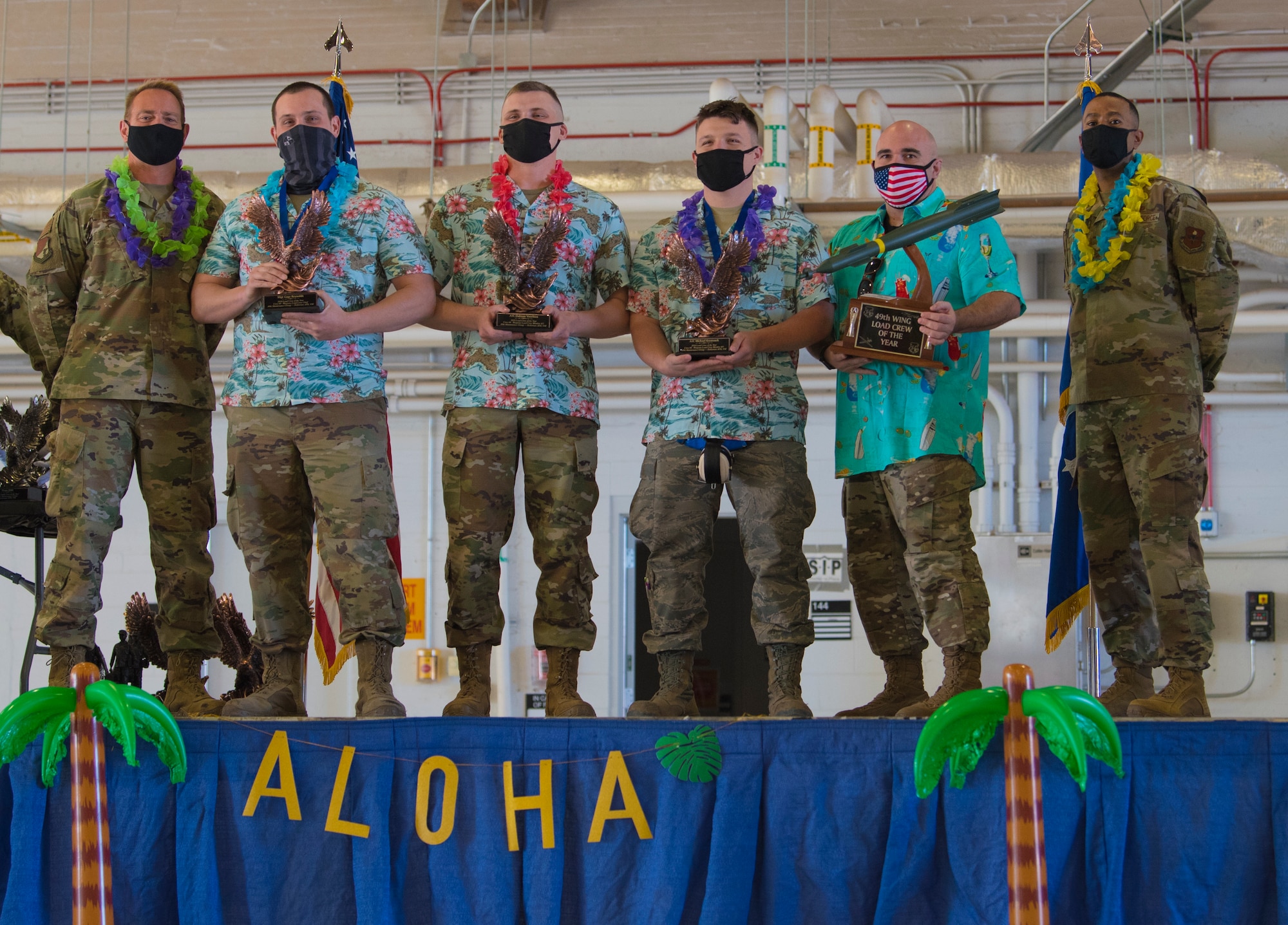 The 9th Aircraft Maintenance Unit was awarded the 49th Wing Load Crew of the Year Award at the 2020 Maintenance Professional of the Year Awards, Feb. 26, 2021, on Holloman Air Force Base, New Mexico. The 9th AMU load crew involved Staff Sgt. Gage Reynolds, Senior Airman Michael Krystosek, and Senior Airman Daltton Voorhies. (U.S. Air Force photo by Airman 1st Class Jessica Sanchez)