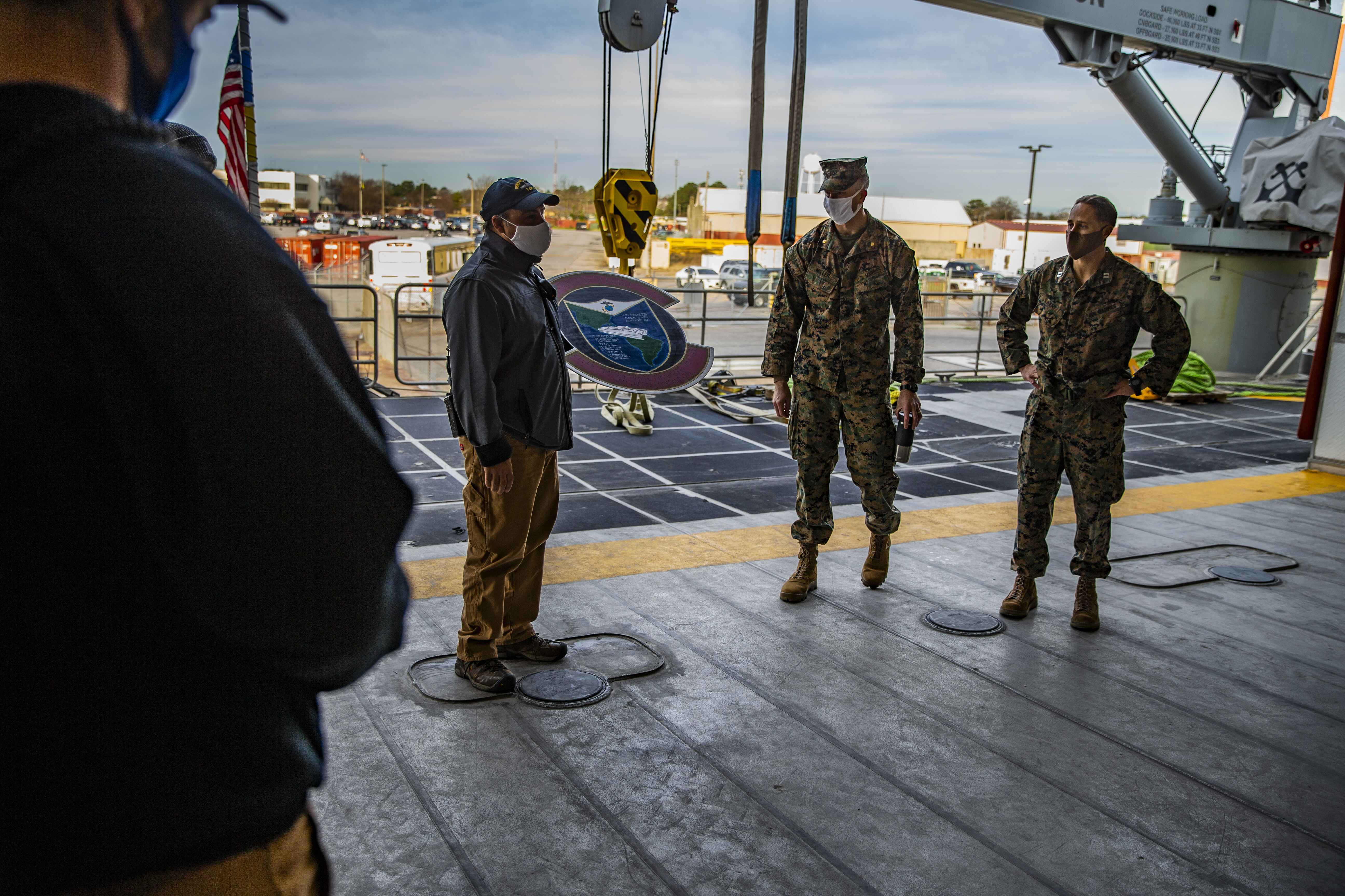 U.S. Marines with Special Purpose Marine Air-Ground Task Force - Southern Command thank the crew of the Spearhead-class USNS Burlington (T-EPF 10) with a metal plaque at Joint Expeditionary Base Little Creek-Fort Story, Virginia, Dec. 28, 2020.