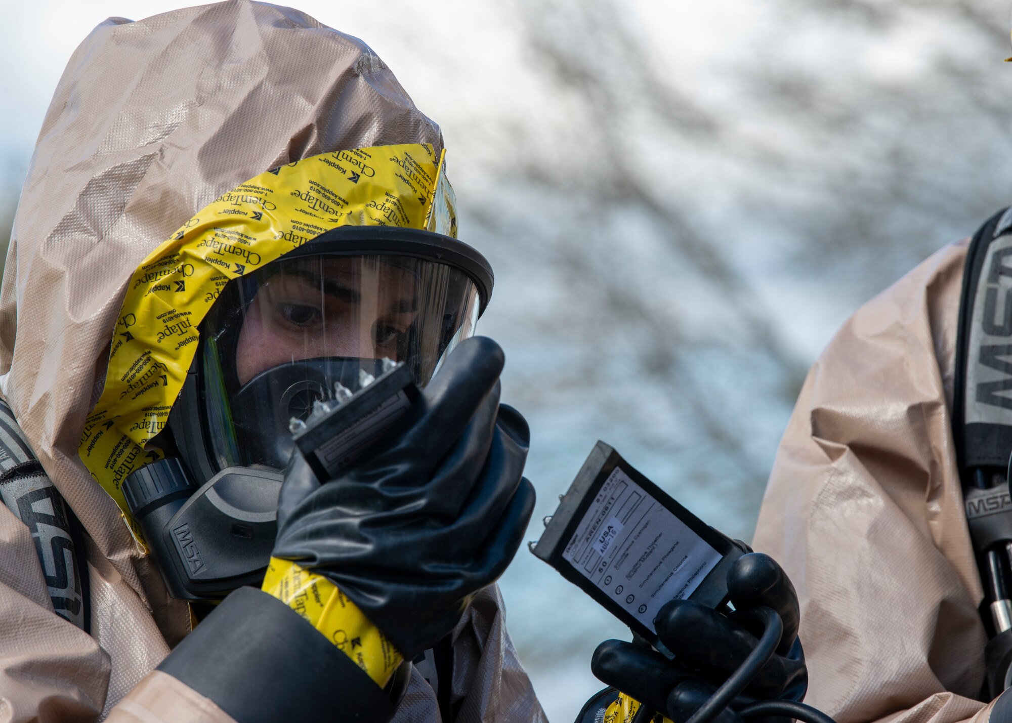 A 6th Medical Group Bioenvironmental Engineering Emergency Response Airman looks at a chemical tester to deduce what type of explosive was used in a simulated bomb during training exercise Ready EAGLE on MacDill Air Force Base, Fla., Feb. 25, 2021. Simulated explosive devices and equipment were used in this scenario. (U.S. Air Force photograph by Airman 1st Class David D. McLoney)
